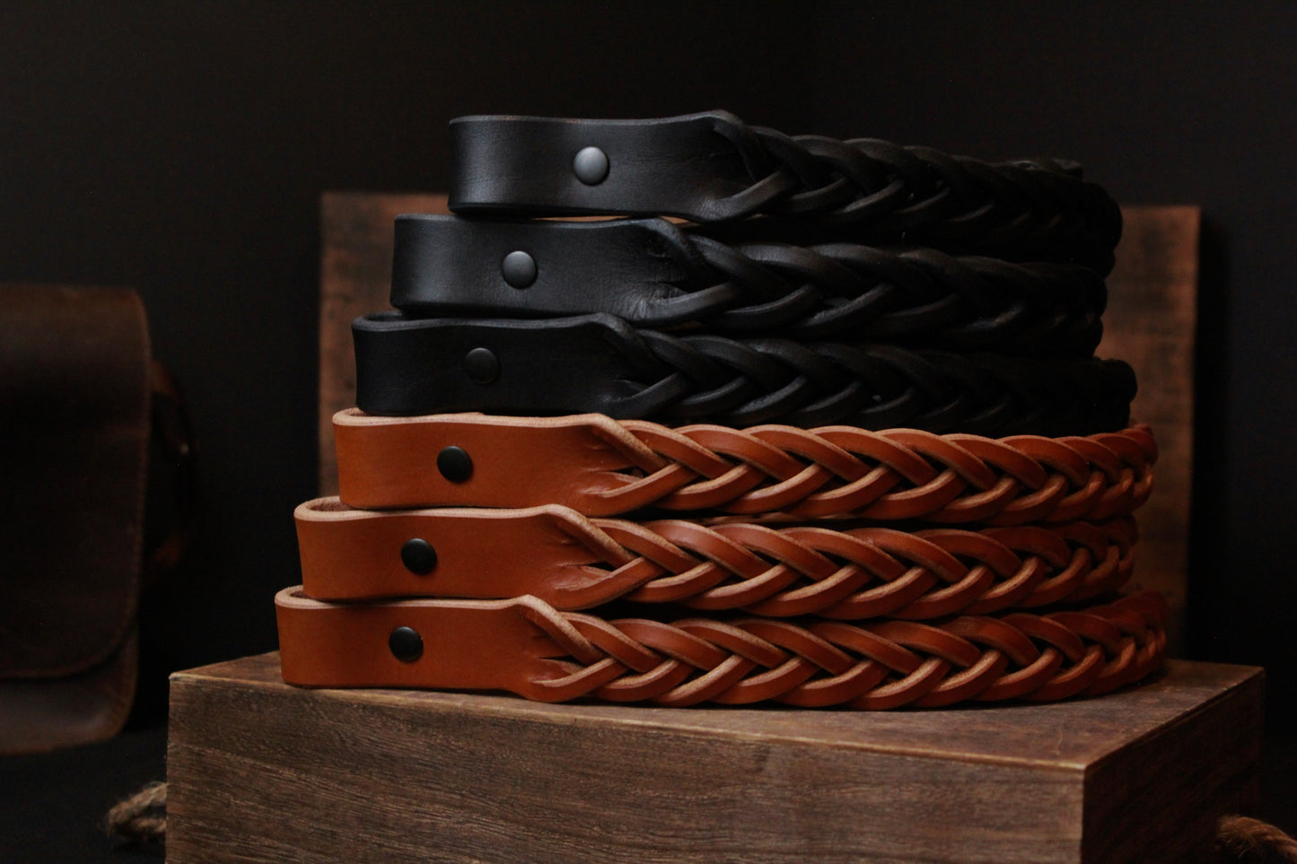 black and brown braided leather gun slings stacked  - braided leather gun straps - 6 pack leather rifle slings - leather rifle straps